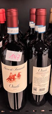several bottles of wine are lined up on a shelf in a store