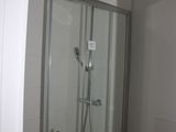 a bathroom with a shower and a sink in it