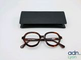 glasses and case on a white surface with a logo on it