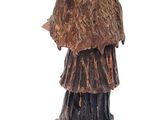 statue of a woman in a fur coat and hat on a book