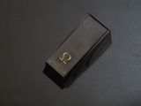 an image of a black box with a gold symbol on it