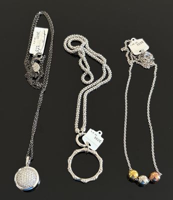 un lot de trois colliers en argent ornés de breloques
