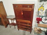a cabinet and a table in the corner of a room