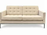 an image of a white couch with a beige upholstered seat