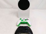 a white xbox one and a green xbox controller