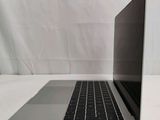 an open laptop computer sitting on top of a white table