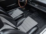 the interior of a classic car with a checkered seat and dashboard