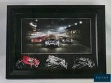 framed photograph of a race car with autographs signed by the drivers