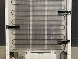 a white refrigerator with a bunch of wires attached to it