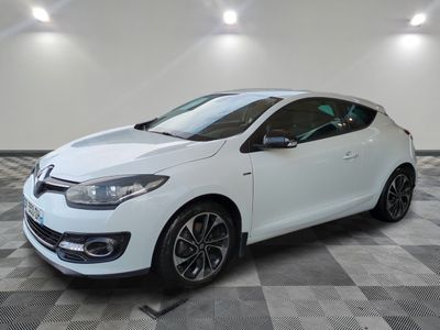 a white car is parked in a room with a checkered floor