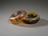 two rings sitting next to each other on a table
