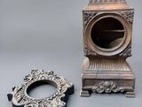 a small clock and a small mirror on a table