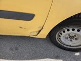 a yellow car that is parked in a parking lot