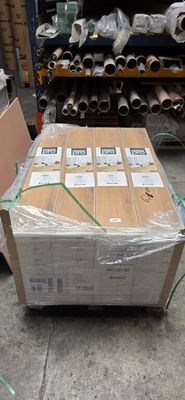 a carton of cardboard sitting on a pallet in a warehouse