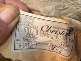 a hand holding a piece of paper that has a ticket on it