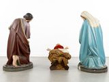three figurines of jesus, mary, and a manger in a white room