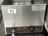stainless steel counter top with a deep fryer in the middle of it