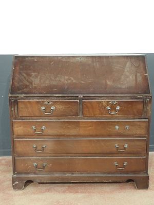 an old wooden chest of drawers on a carpeted floor