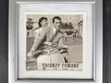 a black and white photo of a man and woman on a scooter