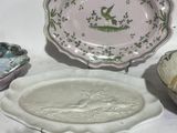 a plate with a bird on it and a bowl with a bird on it