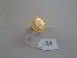 a gold coin on a string with a price tag attached to it
