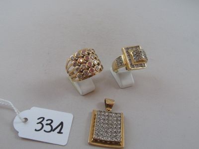 three gold and diamond rings and a pendant with a price tag