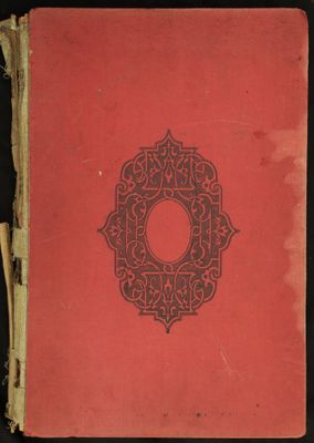 un vieux livre à la couverture rouge posé sur une surface noire