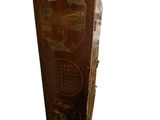 a tall wooden cabinet with asian designs on it