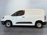 the white van is parked in a room with a gray floor