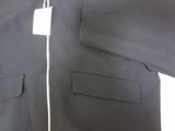 black jacket with a white tag on it sitting on a table