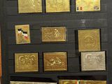 a display of gold and silver coins in a glass case