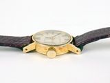 a close up of a wrist watch on a white surface