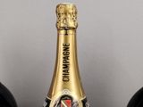 three bottles of champagne sitting on a table next to each other