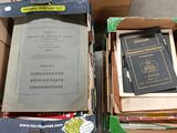 two boxes of books sitting on the floor next to each other