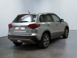 the rear end of a silver suv parked in a room