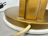 a gold lamp that has a plugged in to it