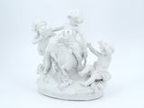 a white figurine of a boy and a girl on a horse