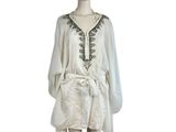 an image of a mannequin wearing a white dress with black embroiderys