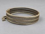 a close up of a bracelet with a chain on it