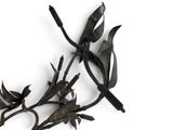 a metal sculpture of a flower on a white surface