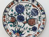 a plate with flowers on it on a white surface