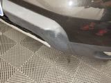 a close up of a car ' s bumper with shoes on it