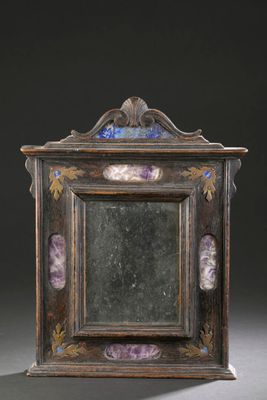 an old wooden frame with a mirror on top of it