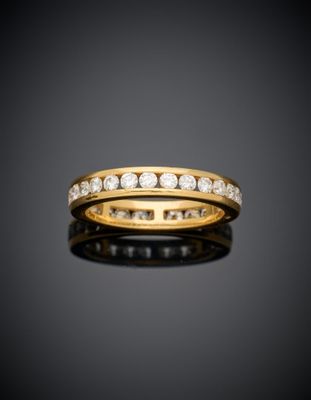 a gold and diamond band ring