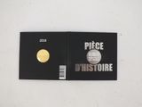 a close up of a book with a gold coin on it