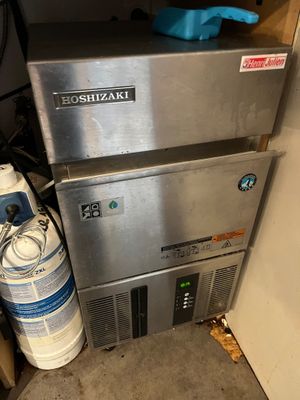 a machine that is sitting next to a bottle of water