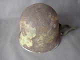 an old helmet with a green paint on it