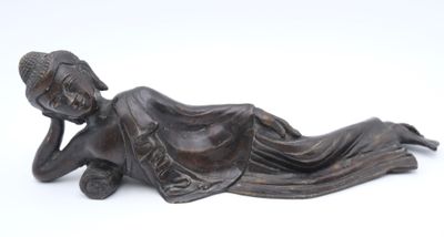 bronze statue of a woman laying on her stomach on a white background