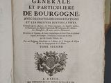 an old book with a black and white image of a coat of arms on top of it