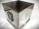 a silver box with a picture on it on a table